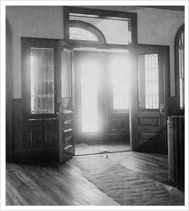 Historic Idylease entrance hall with open doors and leaded glass